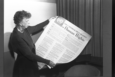 Mrs. Roosevelt holds a Declaration of Human Rights poster, Lake Success, New York, November 1949